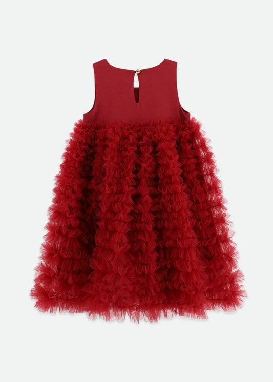 Tibetan red dress made with multiple layers of tulle lace, featuring an Angel's Face signature bow, gold heart charm on the cotton bodice, and a voluminous ruffle skirt. Fastens with a gold logo button at the back