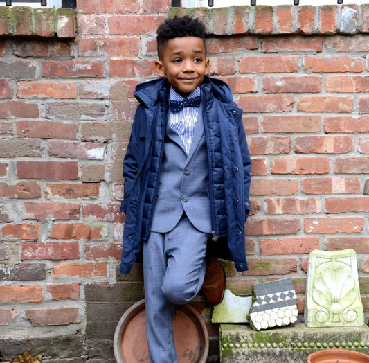New Gotham Coat in navy blue, expertly tailored for the dressiest occasions. Crafted with the finest fabrics, this dashing coat is perfect for holidays, events, or a special tea party. Your little one will look sharp and stylish, ready to impress at any occasion!