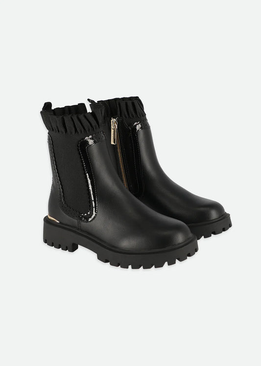 High-profile Chelsea boots with elastic gore, side zip, ruffle detail, and gold logo heart charm, featuring soft velour lining and chunky soles