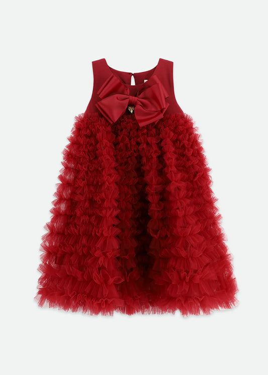 Tibetan red dress made with multiple layers of tulle lace, featuring an Angel's Face signature bow, gold heart charm on the cotton bodice, and a voluminous ruffle skirt. Fastens with a gold logo button at the back
